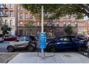 Vehicles at a charging station in Manhattan. Photographer: Jeenah Moon/Bloomberg