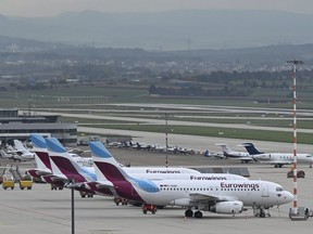 Eurowings aircrafts are parked at the airport in Stuttgart, Germany, Thursday, Oct. 6, 2022. A pilots strike at budget airline Eurowings has forced the German carrier to cancel hundreds of flights Thursday. The airline said about half of its 500 daily flights would be nixed, affecting tens of thousands of passengers in Germany and elsewhere in Europe.