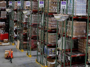 Amazon.com Inc. workers perform their jobs inside of an Amazon fulfillment centre in Robbinsville, New Jersey.