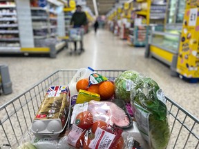 A customer shops for food items inside a Tesco supermarket store in east London, England.