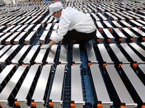 A worker with car batteries at a factory for Xinwangda Electric Vehicle Battery Co. Ltd, which makes lithium batteries for electric cars and other uses, in Nanjing in China's eastern Jiangsu province.