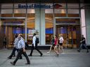 Pedestrians pass in front of a Bank of America Corp. branch in New York, U.S.
