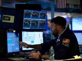 A trader works on the floor of the New York Stock Exchange at Wall Street in New York City.