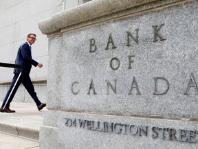 Governor Tiff Macklem walks outside the Bank of Canada building in Ottawa.