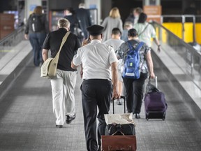 A pilot walks to the parking lot at Terminal 1 of Toronto Pearson International Airport.