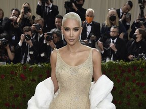FILE - Kim Kardashian attends The Metropolitan Museum of Art's Costume Institute benefit gala celebrating the opening of the "In America: An Anthology of Fashion" exhibition on Monday, May 2, 2022, in New York. Reality tv star and entrepreneur Kim Kardashian has agreed to settle charges brought by the Securities and Exchange Commission and pay $1.26 million because she promoted on social media a crypto asset security offered and sold by EthereumMax without disclosing the payment she received for the plug. The SEC said Monday, Oct. 3, 2022, that Kardashian has agreed to cooperate with its ongoing investigation.
