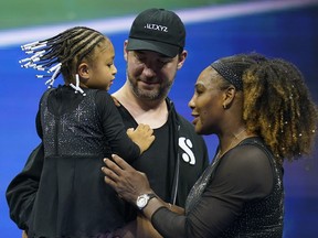 FILE - Serena Williams talks with her daughter Olympia and husband Alexis Ohanian after defeating Danka Kovinic, of Montenegro, during the first round of the U.S. Open tennis championships, Aug. 29, 2022, in New York. Alexis Ohanian called out the need for a safe work environment in the National Women's Soccer League while receiving the Champions for Equality Award at the annual Salute to Women in Sports event on Wednesday night, Oct. 12.
