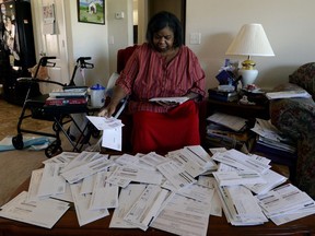 FILE - Debra Smith sorts through her medical bills in her living room on Thursday, Oct. 7, 2021, in Spring Hill, Tenn. Medical bills can quickly become overwhelming, but consumers often have more power than they might think when it comes to navigating them.