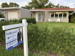 FILE - A home with a "Sold" sign is shown, Sunday, May 2, 2021, in Surfside, Fla. Average long-term U.S. mortgage rates ticked down modestly this week after six straight weeks of gains pushed rates to heights not seen in more than a decade, before a crash in the housing market triggered the Great Recession in 2008. Mortgage buyer Freddie Mac reported Thursday, Oct. 6, 2022, that the average on the key 30-year rate dipped to 6.66% from 6.70% last week.