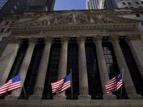 American flags fly outside the New York Stock Exchange, Friday, Sept. 23, 2022, in New York. Stocks tumbled worldwide Friday on more signs the global economy is weakening, just as central banks raise the pressure even more with additional interest rate hikes.