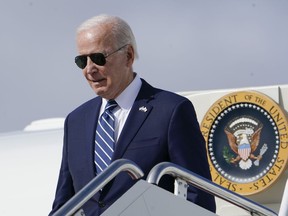 President Joe Biden exits Air Force One as he arrives at Hancock Field Air National Guard Base in Mattydale, N.Y., Thursday, Oct. 27, 2022. Biden traveling to visit the Micron chip facility in Syracuse, N.Y.