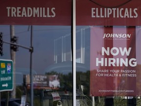 Hiring sign is displayed in Northbrook, Ill., Sept. 21, 2022. The number of Americans applying for unemployment benefits fell last week and remains historically low even as the U.S. economy slows in the midst of decades-high inflation. Jobless claims for the week ending Oct. 15 declined by 12,000 to 214,000 from 226,000 last week, the Labor Department reported Thursday, Oct. 20, 2022.