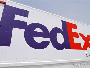 FILE - The FedEx logo is seen on a delivery truck, Tuesday, June 21, 2011, in Springfield, Ill. On Monday, Oct. 17, 2022, a federal judge dismissed FedEx from a lawsuit filed by relatives of five of the eight people who were fatally shot last year at an Indianapolis warehouse by a former employee of the shipping giant.