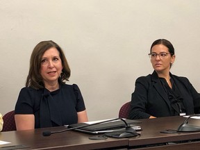 Indiana state Treasurer Kelly Mitchell, left, speaks during a news conference at the Indiana Statehouse in Indianapolis, on July 14, 2022. A judge has thrown out a lawsuit claiming that Mitchell violated state law by awarding contracts worth more than $6 million to firms linked to her political supporters.