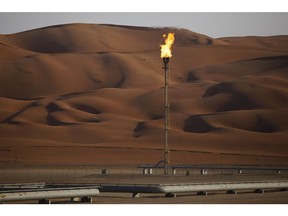 Flames burn off at an oil processing facility in Saudi Aramco's oilfield in the Rub' Al-Khali (Empty Quarter) desert in Shaybah, Saudi Arabia, on Tuesday, Oct. 2, 2018. Saudi Aramco aims to become a global refiner and chemical maker , seeking to profit from parts of the oil industry where demand is growing the fastest while also underpinning the kingdom's economic diversification. Photographer: Simon Dawson/Bloomberg