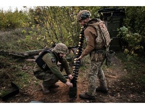 Soldiers of Ukraine's 5th Regiment of Assault Infantry put ammunition into a crate before setting a US-made MK-19 automatic grenade launcher towards Russian positions in less than 800 metres away at a front line near Toretsk in the Donetsk region on October 12. Photographer: Yasuyoshi Chiba/AFP/Getty Images