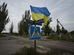 A Ukrainian flag on a street of the recently liberated village of Vysokopillya, Kherson region, Ukraine. Photographer: Genya Savilov/AFP/Getty Images