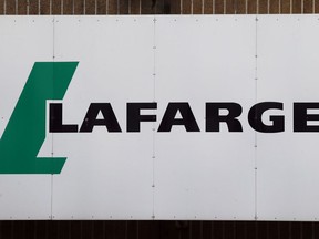 FILE - A logo of Lafarge, the world's largest cement maker, is pictured outside of a facility, in Paris, Sept. 8, 2017. Lafarge has pleaded guilty to paying $17 million to the Islamic State group so that a plant in Syria could remain open, in a case the Justice Department describes as the first of its kind. The charges were announced Tuesday in federal court in New York City. The allegations involve conduct that was earlier investigated by authorities in France.