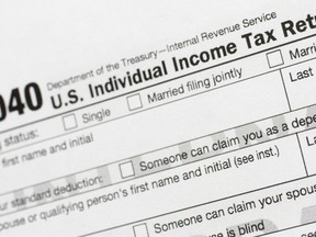 FILE - A portion of the 1040 U.S. Individual Income Tax Return form is shown July 24, 2018, in New York. Taxpayers will get fatter standard deductions for 2023 and all seven federal income tax bracket levels will be revised upward as the government allows people to shield more of their money from taxation because of persistently high inflation. For couples who file jointly for tax year 2023, the standard deduction increases to $27,700 up $1,800 from tax year 2022, the IRS announced.