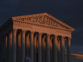 The Supreme Court is seen at sunset in Washington, on Jan. 24, 2019. The Supreme Court will hear arguments on Oct. 11, 2022, over a California animal cruelty law that could raise the cost of bacon and other pork products nationwide.