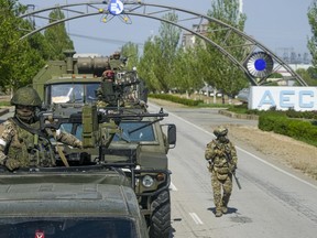FILE - A Russian military convoy is seen on the road toward the Zaporizhzhia Nuclear Power Station, in Enerhodar, Zaporizhzhia region, in territory under Russian military control, southeastern Ukraine, on May 1, 2022. Russia has devised yet another way to spread disinformation about its invasion of Ukraine, using digital tricks that allow its war propaganda videos to evade restrictions imposed by governments and tech companies. (AP Photo/File)
