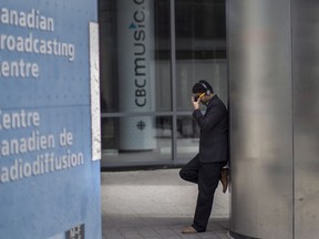 An unidentified man is pictured outside the CBC building in downtown Toronto is seen on Thursday June 26 2014.