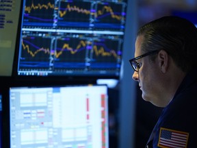 Traders work on the floor at the New York Stock Exchange in New York, Wednesday, Nov. 2, 2022.