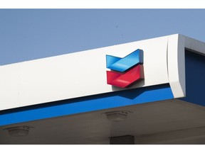 The Chevron Corp. logo is displayed at a gas station in Dallas, Texas, U.S., on Wednesday, July. 26, 2017. Chevron Corp. is scheduled to release earnings figures on July 28. Photographer: Cooper Neill/Bloomberg