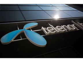 A sign sits on display outside a Telenor Banka AD bank branch, operated by Telenor ASA, in the 'Airport City' business quarter of Belgrade, Serbia, on Wednesday, March 28, 2018. Telenor ASA agreed to sell its businesses in central and eastern Europe to Czech billionaire Petr Kellner's investment firm PPF Group for 2.8 billion euros ($3.4 billion) as the Norwegian phone company focuses on markets in Asia and Scandinavia. Photographer: Oliver Bunic/Bloomberg