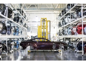 A robot on transports the body of an Aston Martin DBS Superleggera automobile on the production line at the Aston Martin Lagonda Ltd. manufacturing and assembly plant in Gaydon, U.K., on Tuesday, Sept. 4, 2018. Aston Martin is preparing to list its shares in London after the brand synonymous with U.K. spymaster James Bond pulled off a multi-year turnaround.