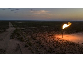 A gas flare is seen at dusk in this aerial photograph taken above a field near Mentone, Texas, U.S., on Saturday, Aug. 31, 2019. Natural gas futures headed for the longest streak of declines in more than seven years as U.S. shale production outruns demand and inflates stockpiles. Photographer: Bronte Wittpenn/Bloomberg