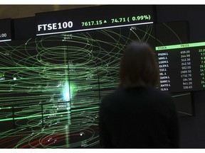 A FTSE share index board in the atrium of the London Stock Exchange.