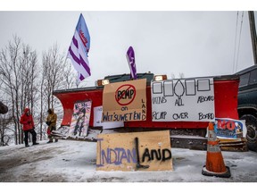 Signs hang from a snowplow during a protest near Belleville, Canada in 2020. Demonstrators blocked railroads and other infrastructure across Canada to protest TC Energy's planned Coastal GasLink pipeline.