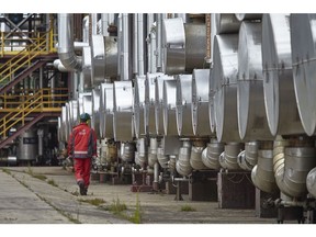 An employee examines pipework in the distillation plant of the PKN Orlen SA oil refinery in Plock, Poland, on Friday, July 17, 2020. Polish refiner PKN Orlen won conditional European Union approval to buy rival Grupa Lotos SA after agreeing on a "extensive" commitments package designed to allay potential competition concerns.