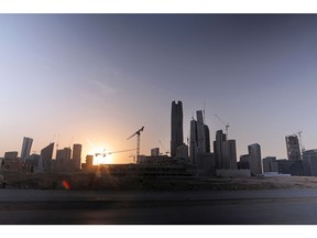 Construction cranes stand between skyscrapers at the King Abdullah Financial District (KAFD) in Riyadh, Saudi Arabia, on Tuesday, July 28, 2020. Saudi Arabia suffered a simultaneous decline in oil and non-oil revenue as the global pandemic combined with lower energy prices to jolt the kingdom's public finances. Photographer: Maya Anwar/Bloomberg