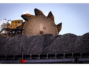 A bucket-wheel reclaimer stands next to a pile of coal at the Port of Newcastle. Photographer: David Gray/Bloomberg