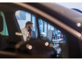An employee speaks on the telephone in the showroom of an automobile dealership, operated by Pentagon Motor Group, a division of Motus Holdings Ltd., in Lincoln, U.K., on Wednesday, Oct. 21, 2020. As the earnings season picks up pace, an improving outlook for carmakers may further boost the sector thats already leading Europes stock rebound since March.