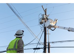 A worker repairs a power line in Austin, Texas, U.S., on Saturday, Feb. 20, 2021. Restaurants in Texas are throwing out expired food, grocery stores are closing early amid stock shortages and residents are struggling to find basic necessities as a cold blast continues to upend supply chains.
