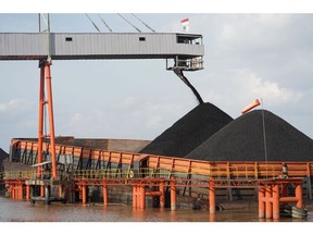 Coal is loaded onto a barge at a terminal operated by PT Bara Kumala Sakti in Kutai Kartanegara, East Kalimantan, Indonesia, on Wednesday, Oct. 13, 2021. Coal prices are likely to remain high after soaring to new records on strengthening power demand and challenges in key supplier nations, according to a major Australian producer.