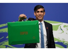 GLASGOW, SCOTLAND - NOVEMBER 03: Chancellor of the Exchequer, Rishi Sunak, arrives at COP26 with his Green Budget Box where he will lead Finance Day and deliver a keynote speech to COP26 delegates at SECC on November 03, 2021 in Glasgow, Scotland. Rishi Sunak will be setting out plans to encourage UK industry to work towards the country's 2050 net zero target.