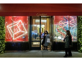 A customer exits from the Cartier jewelry store on Fifth Avenue in New York, U.S., on Thursday, Dec. 2, 2021. U.S. retail sales strengthened from Nov. 3-23, rising 15.5% as an earlier holiday push and Black Friday deals, and concern over product shortages, may have pulled forward demand. Photographer: Christopher Occhicone/Bloomberg