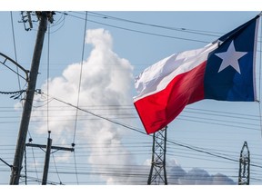 HOUSTON, TEXAS - JANUARY 21: The Texas state flag is seen near an oil refinery on January 21, 2022 in Houston, Texas. Oil prices have retreated from seven-year highs after an unexpected rise in U.S. crude and fuel inventories.