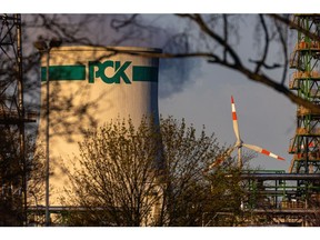 A wind turbine beyond the PCK Schwedt oil refinery operated by PCK Raffinerie GmbH, a subsidiary of Rosneft Oil Co., in Schwedt, Germany, on Thursday, April 7, 2022. The PCK refinery, which handles Russian oil delivered via the Druzhba pipeline, supplies 95% of the gasoline, diesel, heating oil and kerosene to Berlin and Brandenburg.