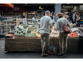 Customers shop at a vegetable stall in the Capucin Market in Bordeaux, France, on Friday, May 27, 2022. France's headline inflation is likely to accelerate to 5.6% in May from 5.4% in April, as food prices and road fuel costs increase, according to Bloomberg Economics' estimates.