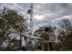 A technician works on a wildfire detection system consisting of five solar-powered camera towers that monitor protected areas in the Pantanal Wetlands, Mato Grosso do Sul state, Brazil, on Tuesday, June 7, 2022. Following the catastrophic 2020 fires in the Pantanal, the worst season on record, a new system is being installed that will monitor nearly 2.5 million hectares of wildland in an effort to preserve the delicate agroforestry of the world's largest tropical wetland area.