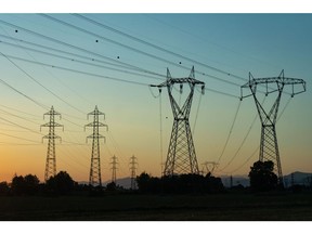 Electricity transmission towers and power lines in Brescia, Italy, on Sunday, July 3, 2022. Italy's government plans further measures to cushion the impact of high energy prices, including extending a fuel tax holiday to the beginning of October, Il Messaggero newspaper reported.
