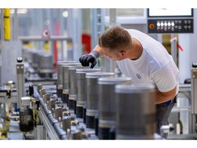 An employee checks the finished components on the electric motor rotor production line at the SalzGiga fuel cell gigafactory, operated by Volkswagen Group Components, in Salzgitter, Germany, on Wednesday, May 18, 2022. VW's future battery hub at Salzgitter will start production in 2025 for the company's volume cars. Photographer: Krisztian Bocsi/Bloomberg