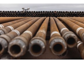 Stacks of steel pipes used for drilling oil wells at a drilling site on the land that the University of Texas System overseas in Andrews, Texas, US, on Thursday, June 2, 2022. Every day, the University of Texas System makes about $6 million off a mineral-rich swath of land it manages in the US's largest oil field. Photographer: Jordan Vonderhaar/Bloomberg
