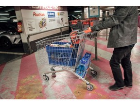 A shopper pushes their shopping cart in the parking lot of an Auchan Retail SA supermarket in Paris, France, on Monday, Oct. 10, 2022. Food prices have overtaken energy as the biggest factor behind inflation in France and will continue to lead the cost of living higher through the end of the year, according to the latest forecasts from statistics agency Insee. Photographer: Cyril Marcilhacy/Bloomberg