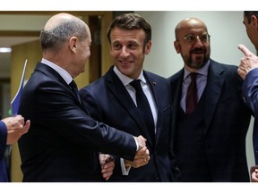 Olaf Scholz greets Emmanuel Macronat the European Union (EU) leaders summit in Brussels, Belgium, on Oct. 21.